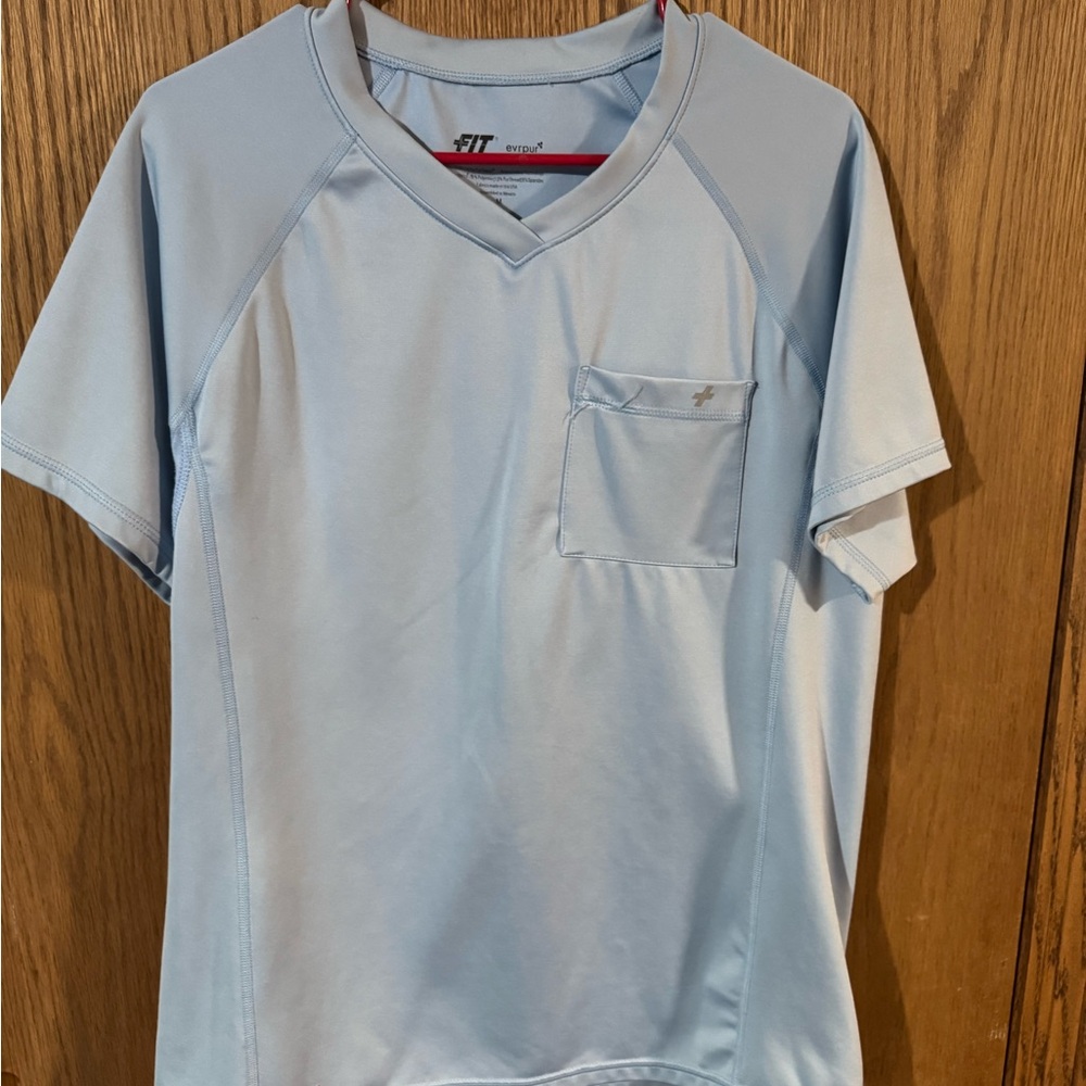 Light Blue Fit Scrubs men’s top. Silver thread for bacteria resistance.